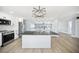 Spacious kitchen features stainless appliances, large island, and an open floor plan at 6410 3Rd Palm Pt, St Pete Beach, FL 33706