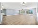 Open living area with sleek flooring, large windows, and a sliding glass door with a water view at 6410 3Rd Palm Pt, St Pete Beach, FL 33706