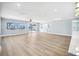Large, open living room with wood floors, recessed lighting, and a view of the water at 6410 3Rd Palm Pt, St Pete Beach, FL 33706