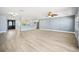 Bright living room with a view into the kitchen, complete with pendant lights and stainless appliances at 6410 3Rd Palm Pt, St Pete Beach, FL 33706