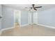 Main bedroom with stylish ceiling fan, neutral walls, and an en suite bathroom at 6410 3Rd Palm Pt, St Pete Beach, FL 33706