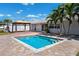 Inviting backyard oasis featuring a pool, gazebo, and lush greenery at 6410 3Rd Palm Pt, St Pete Beach, FL 33706