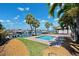 Pool and patio with tropical foliage near the waterfront and a boat dock at 6410 3Rd Palm Pt, St Pete Beach, FL 33706