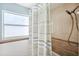 Shower featuring striped curtain, tiled walls and floors, and convenient showerhead at 6410 3Rd Palm Pt, St Pete Beach, FL 33706