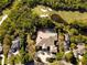 Aerial view of luxury home featuring screened pool, large lot and proximity to golf course and lake at 6413 Maclaurin Dr, Tampa, FL 33647