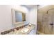 Stylish bathroom featuring granite countertops, a large mirror, and a glass-enclosed shower at 6413 Maclaurin Dr, Tampa, FL 33647