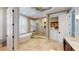 Bathroom featuring a soaking tub, walk-in shower, double vanity, and tiled floors at 6413 Maclaurin Dr, Tampa, FL 33647