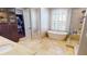 Bright bathroom features a soaking tub, walk-in shower, and vanity with marble countertops at 6413 Maclaurin Dr, Tampa, FL 33647
