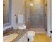 Elegant bathroom with a granite countertop, a glass-enclosed shower and neutral colored tile at 6413 Maclaurin Dr, Tampa, FL 33647