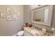 Neutral colored bathroom with a granite countertop, a large mirror, and decorative art at 6413 Maclaurin Dr, Tampa, FL 33647