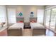 Bedroom with two beds, neutral walls, hardwood floors, and a sliding glass door at 6413 Maclaurin Dr, Tampa, FL 33647