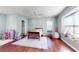 Charming bedroom with dark wood floors, a ceiling fan, and bright natural light from the large window at 6413 Maclaurin Dr, Tampa, FL 33647