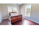 Cozy bedroom with hardwood floors and natural light from two large windows at 6413 Maclaurin Dr, Tampa, FL 33647