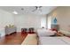 Spacious bedroom featuring neutral walls, hardwood floors, ceiling fan, and two beds at 6413 Maclaurin Dr, Tampa, FL 33647