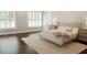 Comfortable bedroom featuring a queen size bed and windows with bright, white shutters at 6413 Maclaurin Dr, Tampa, FL 33647