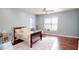 Cozy bedroom featuring a large window, a ceiling fan, and stylish decor on the shelving and windowsill at 6413 Maclaurin Dr, Tampa, FL 33647