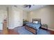 Bedroom featuring hardwood floors, ceiling fan, neutral walls, and a desk at 6413 Maclaurin Dr, Tampa, FL 33647