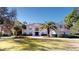 Beautiful two-story white home with a circular driveway and well-manicured landscaping at 6413 Maclaurin Dr, Tampa, FL 33647