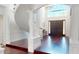 Grand foyer with high ceilings, dark hardwood floors, and a winding staircase at 6413 Maclaurin Dr, Tampa, FL 33647