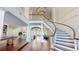 Bright foyer features a winding staircase, chandelier, and hardwood flooring at 6413 Maclaurin Dr, Tampa, FL 33647