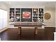 Spacious game room features built-in shelving, hardwood floors, and a ping pong table at 6413 Maclaurin Dr, Tampa, FL 33647
