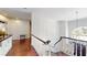 Hallway with staircase overlooking foyer with chandelier and high ceilings at 6413 Maclaurin Dr, Tampa, FL 33647