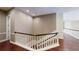 Open hallway showcasing hardwood floors and white wainscoting up the staircase at 6413 Maclaurin Dr, Tampa, FL 33647