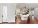 Bright kitchen features white cabinetry, stainless steel appliances, a large island, and rich wood floors at 6413 Maclaurin Dr, Tampa, FL 33647