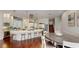Open kitchen with marble countertops, stainless steel appliances, and a bar with stool seating at 6413 Maclaurin Dr, Tampa, FL 33647