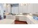 Modern kitchen featuring white cabinets, stainless steel appliances, and stone backsplash at 6413 Maclaurin Dr, Tampa, FL 33647