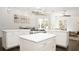 Open kitchen with center island, marble countertops, stainless steel appliances, and backyard views at 6413 Maclaurin Dr, Tampa, FL 33647