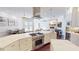 Modern kitchen boasts stainless steel appliances, an expansive island, and an open design flowing into the living area at 6413 Maclaurin Dr, Tampa, FL 33647