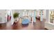 Open-concept living area with hardwood floors, white walls, and a view of the pool at 6413 Maclaurin Dr, Tampa, FL 33647