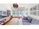 Casual living room area featuring a large window view of the beautiful backyard swimming pool at 6413 Maclaurin Dr, Tampa, FL 33647