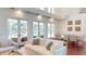 Bright living room with ample seating, pool view through French doors, and formal dining area at 6413 Maclaurin Dr, Tampa, FL 33647