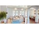 Bright living room with French doors, hardwood floors, and open access to dining area at 6413 Maclaurin Dr, Tampa, FL 33647
