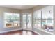 Living room showcasing wood floors with views of the outdoor kitchen and entertaining area at 6413 Maclaurin Dr, Tampa, FL 33647