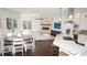 Open living area with kitchen, fireplace, wood floors, and view to backyard pool at 6413 Maclaurin Dr, Tampa, FL 33647