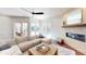 Bright living room featuring a stone fireplace and sliding glass doors to the backyard pool area at 6413 Maclaurin Dr, Tampa, FL 33647