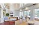 Bright living area with high ceilings, fireplace, and view of the outdoor living space at 6413 Maclaurin Dr, Tampa, FL 33647