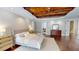 Main bedroom features wood-look floors, neutral walls, and decorative wood beam ceiling at 6413 Maclaurin Dr, Tampa, FL 33647