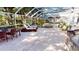 Outdoor living area featuring a screened pool, spa, dining, and lounge seating at 6413 Maclaurin Dr, Tampa, FL 33647