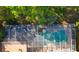 Aerial view of screened pool area featuring patio furniture, lush landscaping, and ample space for relaxation at 6413 Maclaurin Dr, Tampa, FL 33647