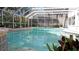 Inviting screened pool with a tranquil view of the surrounding backyard and landscaping at 6413 Maclaurin Dr, Tampa, FL 33647