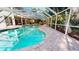 Relaxing screened pool with lush tropical surroundings and a spacious deck at 6413 Maclaurin Dr, Tampa, FL 33647