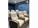 View of several plush reclining chairs with built-in cup holders, in a home theater with dark blue walls at 6413 Maclaurin Dr, Tampa, FL 33647