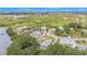 An aerial view of residential community with green landscape near the water, complemented by lush surrounding trees at 734 Weedon Ne Dr, St Petersburg, FL 33702