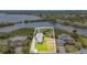 Aerial view of a beautiful home with a well-maintained lawn, lush greenery, and a waterfront view of the bay at 734 Weedon Ne Dr, St Petersburg, FL 33702