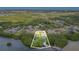Stunning aerial view of a waterfront home surrounded by lush vegetation and water, including a private dock at 734 Weedon Ne Dr, St Petersburg, FL 33702
