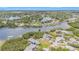 Scenic aerial view of a community near a lake with multiple homes and lush greenery at 734 Weedon Ne Dr, St Petersburg, FL 33702